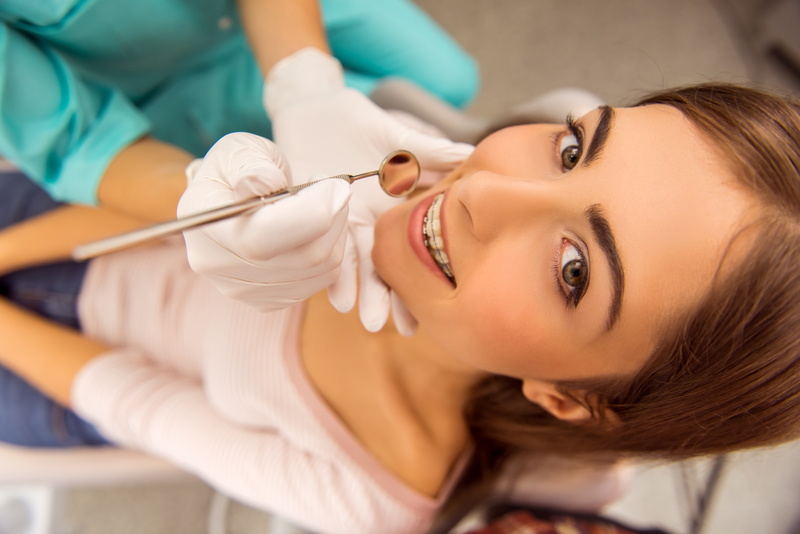 Young girl with braces receiving dental care