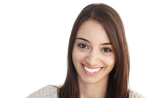 Photo of a woman smiling with straight, white teeth