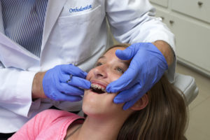Young girl receiving dental care with braces