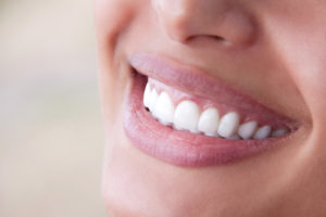 A close-up view of a woman's teeth that are beautiful and straight.